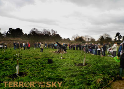 Visitorsto Forty Hall Farm Orchard get ready to see the fire sculpture lit.