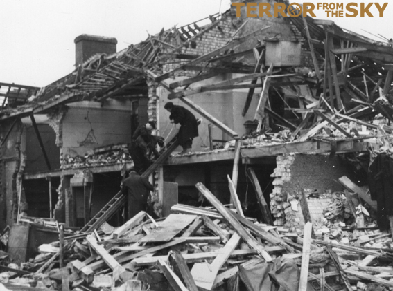 A closer view of the Mapleton Road damage which also shows a rescue dog being assisted to/from inspection of a first floor room.